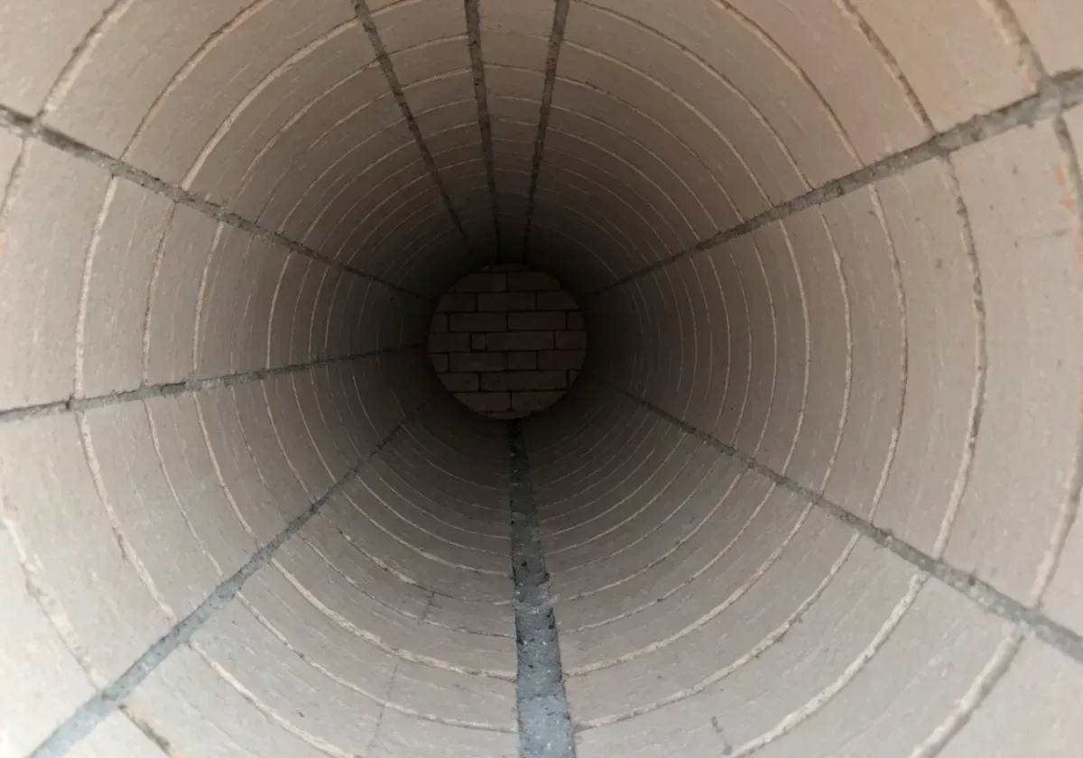 After — creosote removal: Stage 3 glaze stripped from the flue walls — the fuel for a chimney fire, removed.